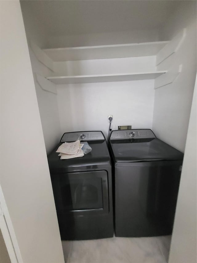 clothes washing area featuring washer and dryer