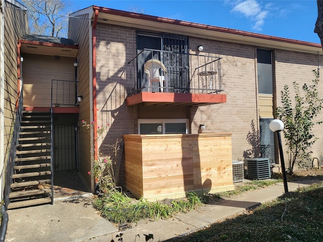 exterior space with a balcony and central AC unit