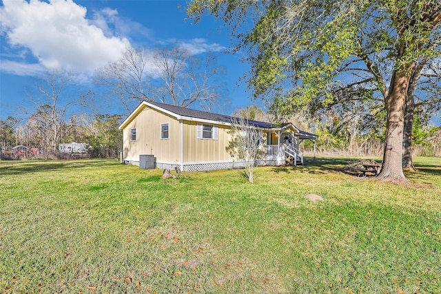 view of home's exterior with central AC unit and a lawn