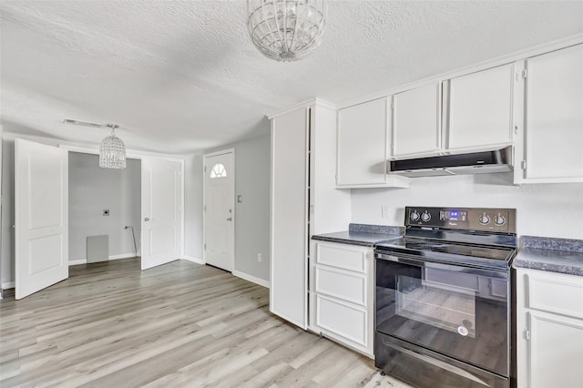 kitchen featuring white cabinetry, black electric range, and a notable chandelier