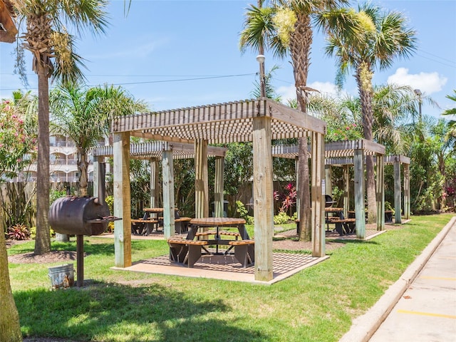 view of home's community with a lawn and a pergola