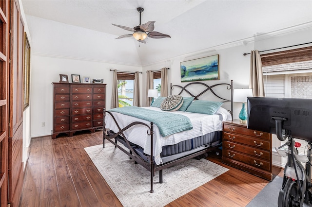 bedroom with dark hardwood / wood-style floors, vaulted ceiling, ceiling fan, and crown molding