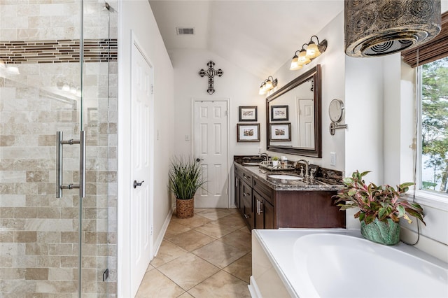 bathroom featuring vanity, separate shower and tub, vaulted ceiling, and tile patterned flooring