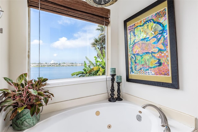 bathroom featuring a tub and a water view