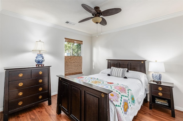 bedroom with ceiling fan, crown molding, and light hardwood / wood-style floors