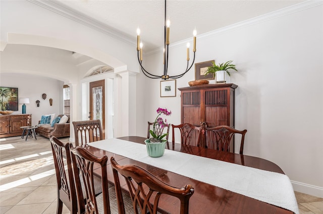 dining area with light tile patterned flooring, a chandelier, and ornamental molding