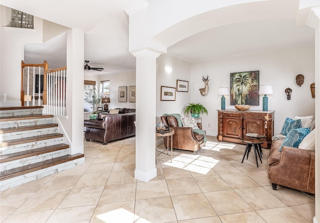 interior space featuring decorative columns and ceiling fan