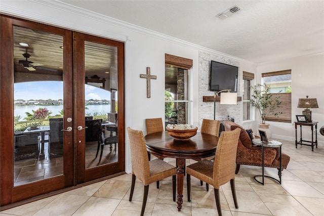 dining room with french doors, ornamental molding, ceiling fan, and a healthy amount of sunlight