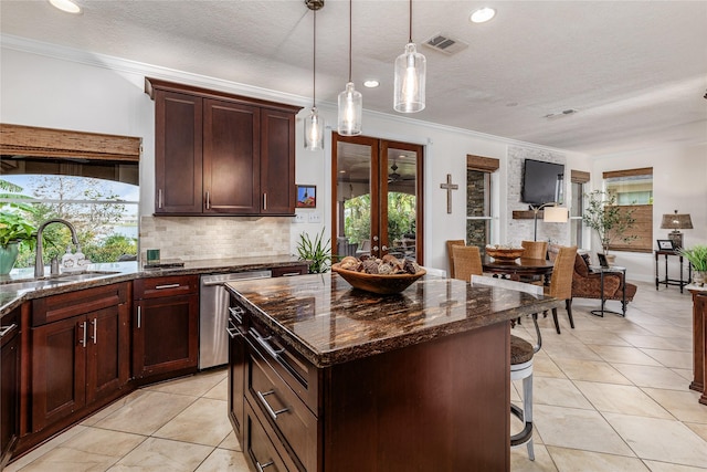 kitchen featuring dishwasher, a center island, french doors, sink, and decorative light fixtures