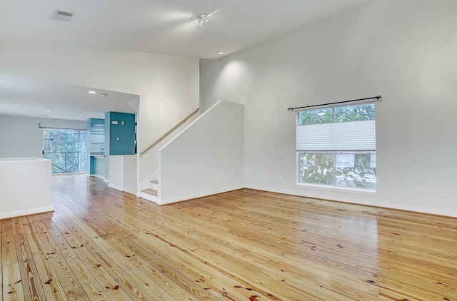 unfurnished living room with light hardwood / wood-style flooring and plenty of natural light