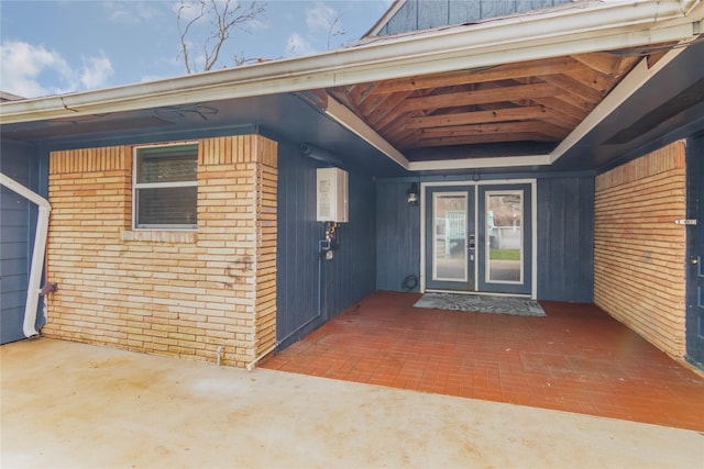 doorway to property featuring brick siding and board and batten siding