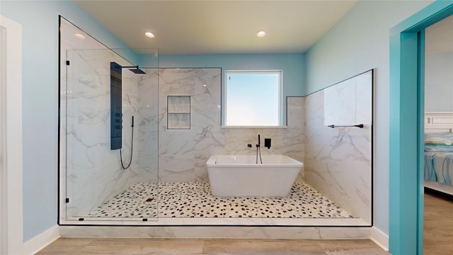 bathroom featuring hardwood / wood-style floors and separate shower and tub