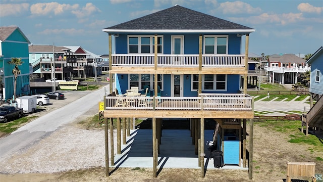 back of property featuring a carport and a wooden deck