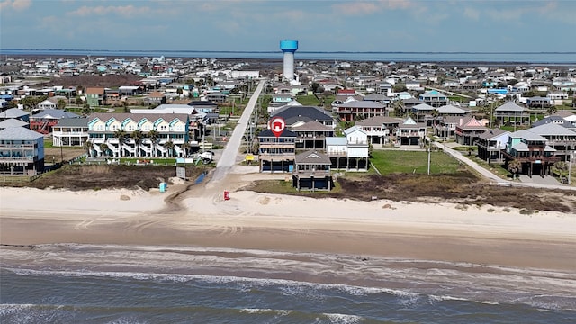 drone / aerial view featuring a water view and a beach view