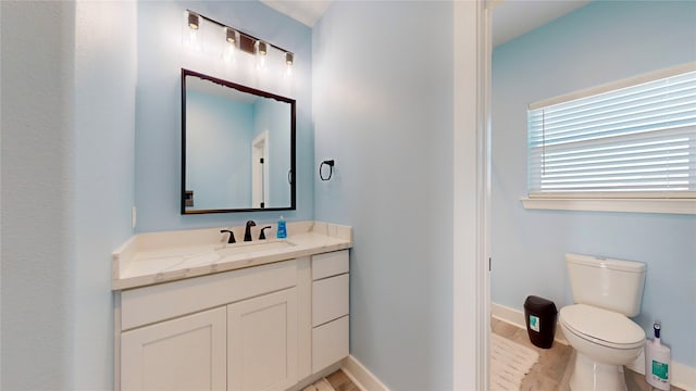 bathroom featuring hardwood / wood-style flooring, vanity, and toilet