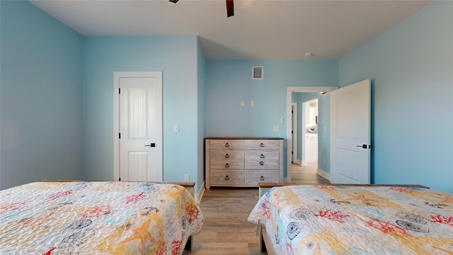 bedroom with light hardwood / wood-style floors and ceiling fan