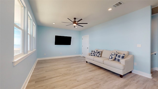 living room featuring light wood-type flooring and ceiling fan