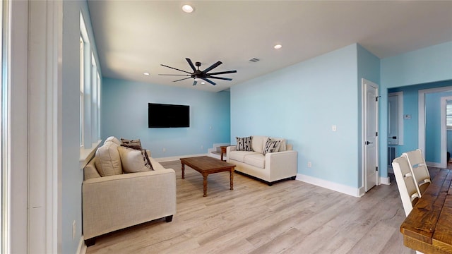 living room with ceiling fan and light hardwood / wood-style floors