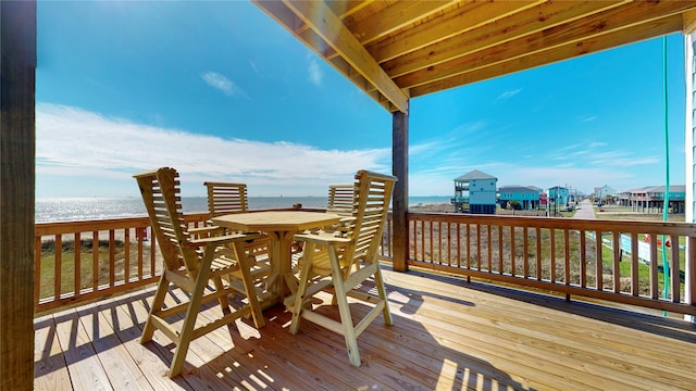 deck with a water view and a beach view