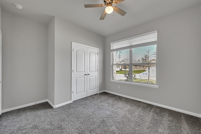 unfurnished bedroom with carpet, ceiling fan, and a closet