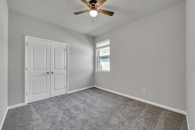 unfurnished bedroom with carpet, ceiling fan, and a closet