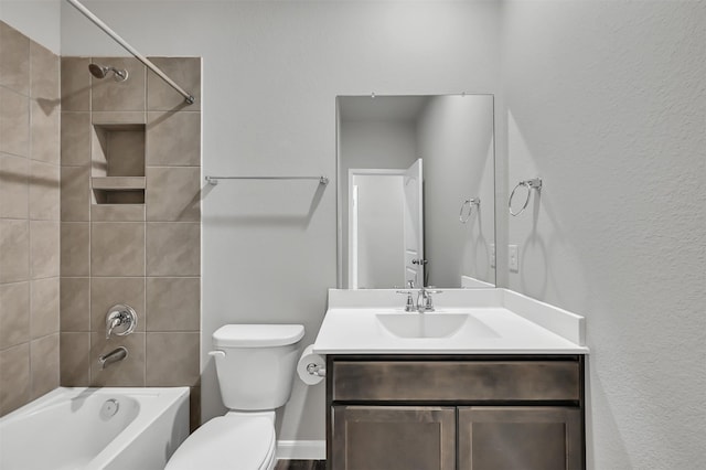 full bathroom with vanity, toilet, and tiled shower / bath combo