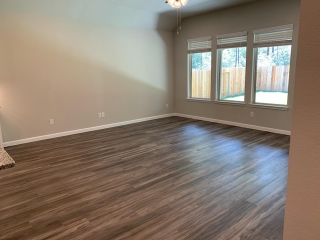 spare room with dark hardwood / wood-style floors