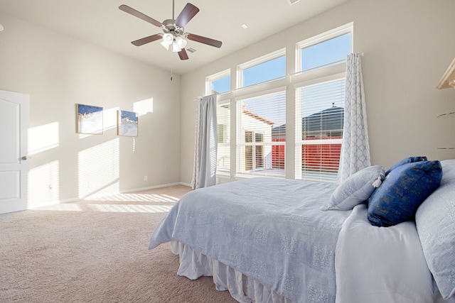 bedroom featuring ceiling fan and light carpet