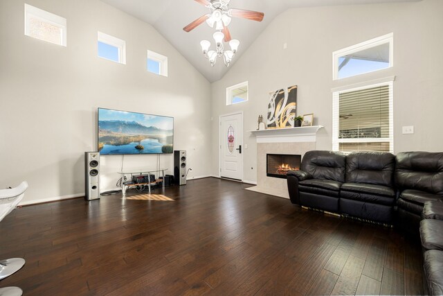 living room featuring ceiling fan, a fireplace, high vaulted ceiling, and wood-type flooring