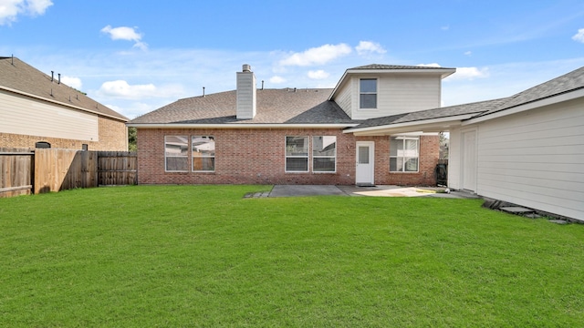 back of house featuring a yard and a patio