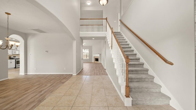 tiled entrance foyer with a chandelier