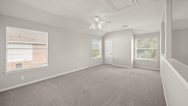 spare room with light carpet, ceiling fan, and lofted ceiling