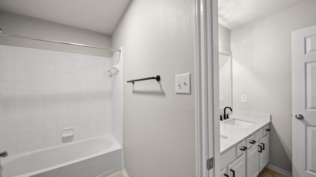 bathroom featuring tile patterned flooring, vanity, and bathing tub / shower combination