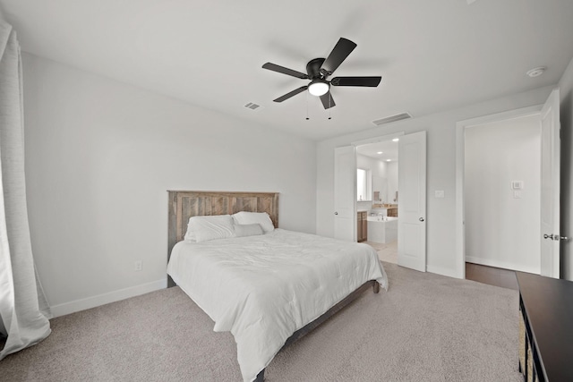 carpeted bedroom featuring connected bathroom and ceiling fan