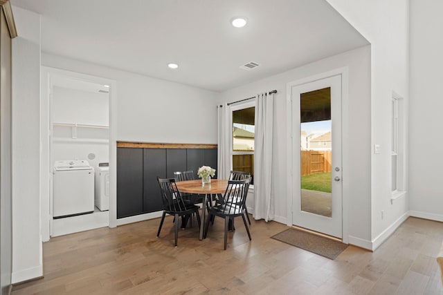 dining room with light wood-type flooring and washer and clothes dryer