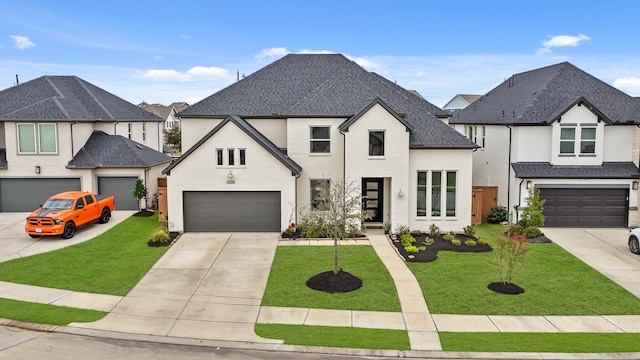 view of front of property featuring a front lawn and a garage