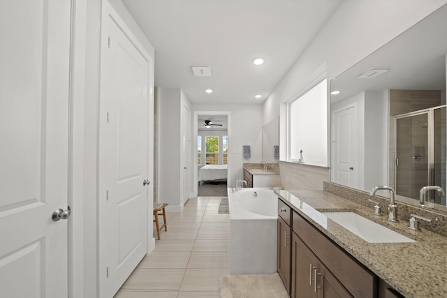 bathroom with tile patterned flooring, ceiling fan, independent shower and bath, and vanity