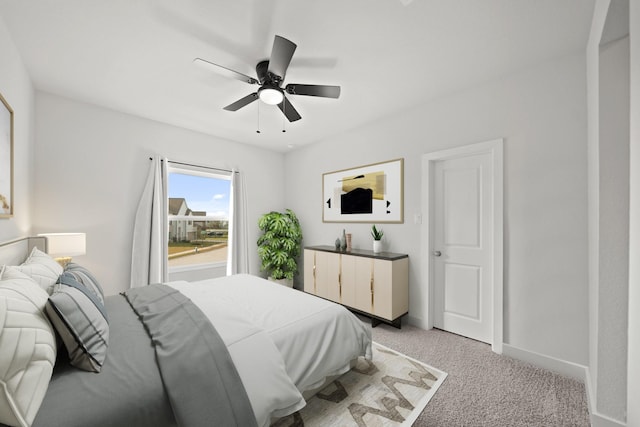 bedroom featuring ceiling fan and light carpet