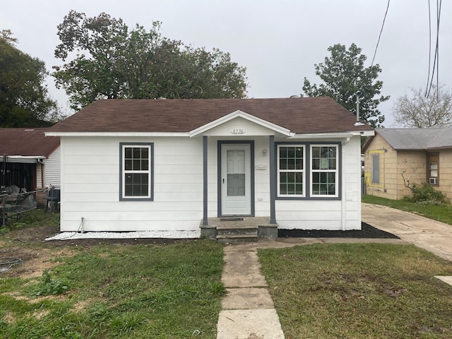 bungalow-style house featuring a front yard