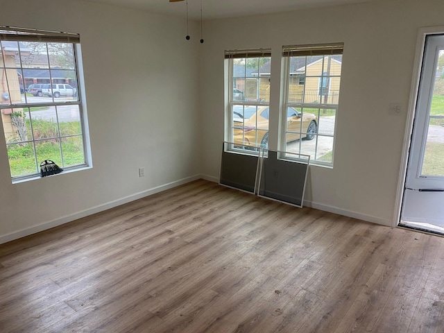 unfurnished room with ceiling fan and light wood-type flooring