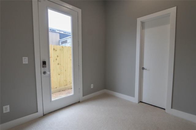 doorway with a healthy amount of sunlight and light colored carpet