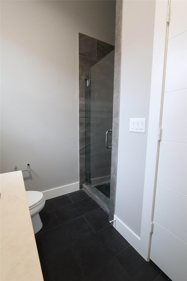 bathroom featuring toilet, tile patterned floors, and walk in shower