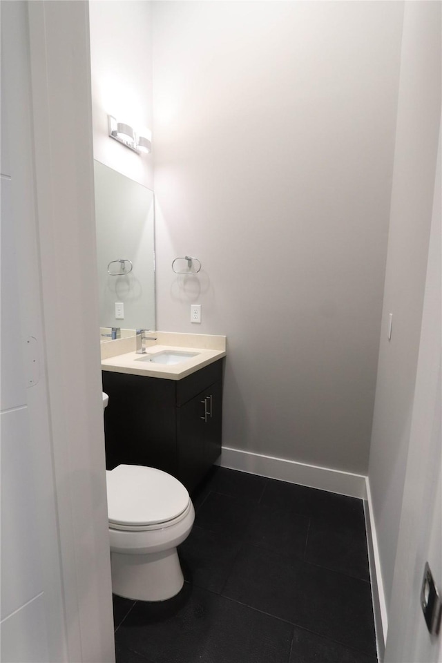 bathroom featuring tile patterned flooring, vanity, and toilet