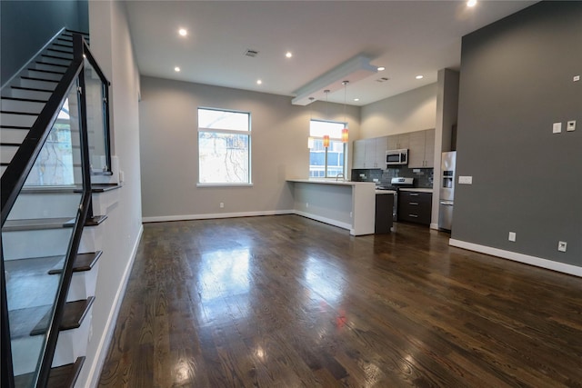 unfurnished living room with sink and dark hardwood / wood-style floors