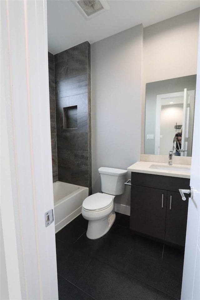 full bathroom with vanity, tiled shower / bath combo, and toilet