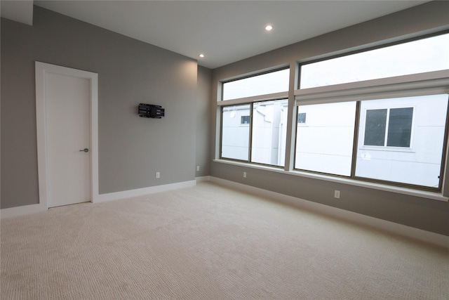 carpeted spare room with a healthy amount of sunlight