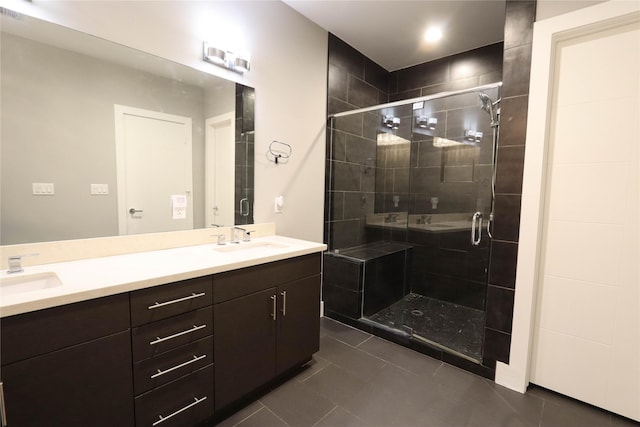 bathroom with tile patterned flooring, vanity, and an enclosed shower