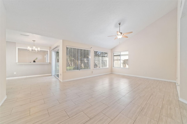 unfurnished room with ceiling fan with notable chandelier and lofted ceiling