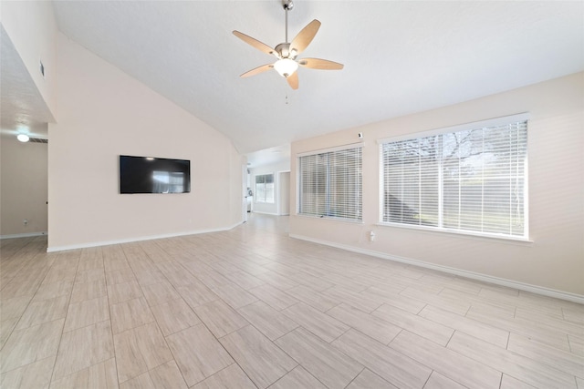 unfurnished living room with ceiling fan and vaulted ceiling