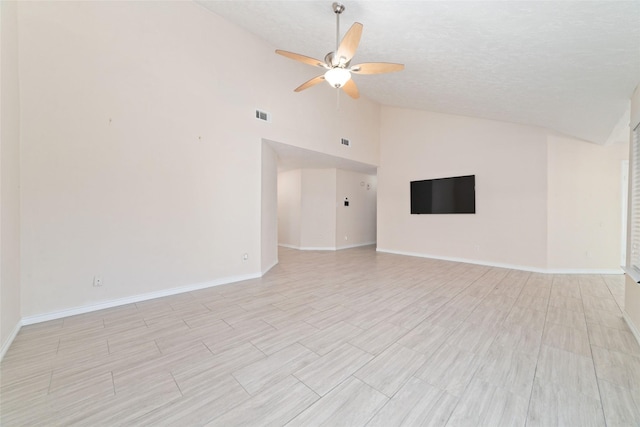 spare room with ceiling fan, high vaulted ceiling, and a textured ceiling